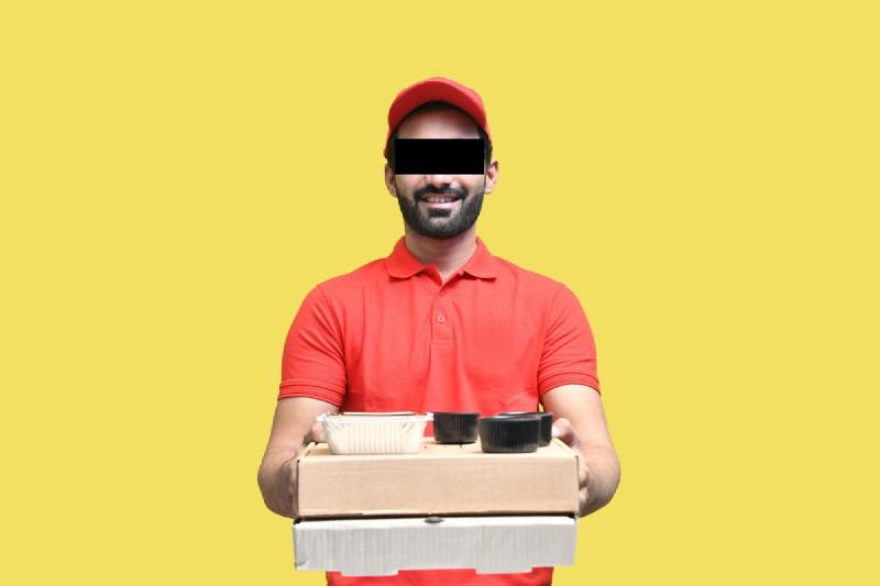A smiling delivery courier holding food containers and pizza boxes